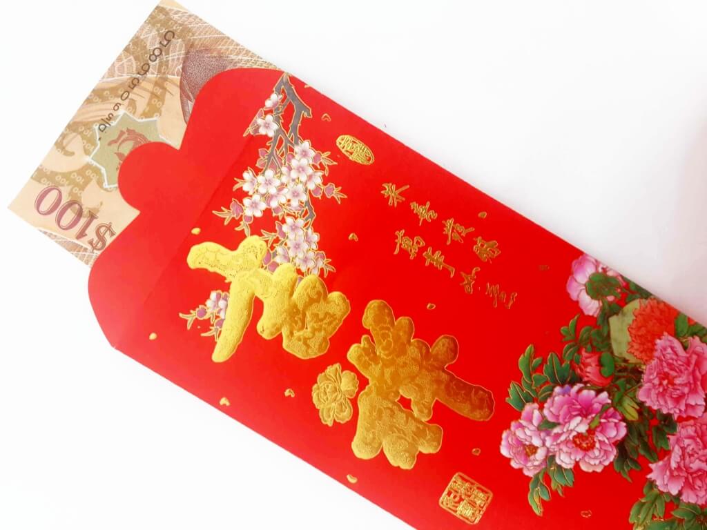 Picture of red envelope with $100 inside