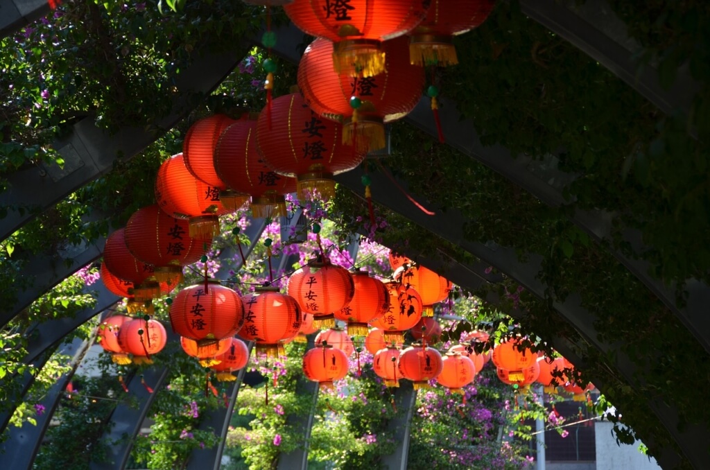 Photo of trellace with red lanterns and flowers
