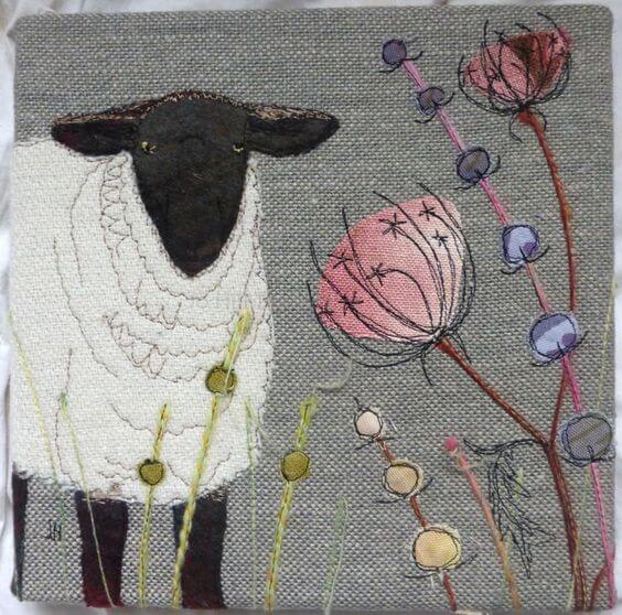 applique sheep and flowers on a quilted background